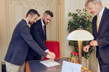 Gay couple stamping the official wedding documents.