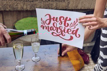 Just married sign next to sparkling wine being poured into a glass.