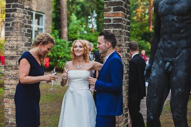Bride enjoying a glass of champagne with guests.