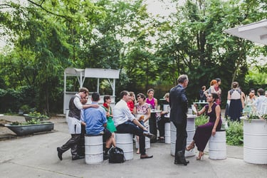 The outdoor area of the old carpet factory filled with wedding guests.