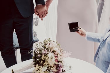 Boy giving bride and groom their wedding bands.