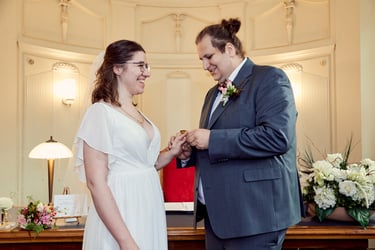 Bride and groom exchanging rings during a wedding ceremony.