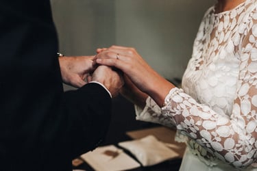 Bride and groom holding hands during a civil ceremony.
