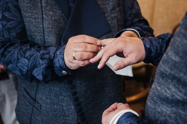Grooms exchanging wedding rings.