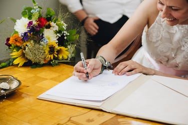 Bride signing wedding documents.