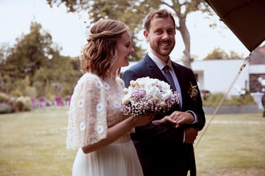 Smiling bride and groom entering reception.