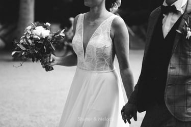 Bride and groom holding hands walking.