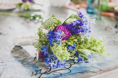 A bridal bouquet tied with a ribbon on a table.