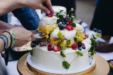 Bride picking up a piece of the ice-cream wedding cake.