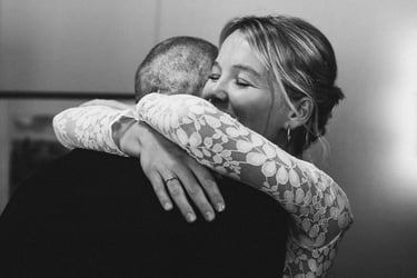 Bride hugging groom during wedding ceremony.
