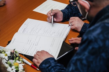 Grooms signing wedding documents.