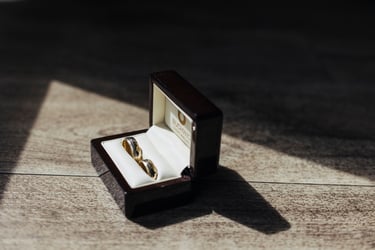 A box with wedding rings lit up by sun rays.