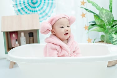 Essential baby bath products including bathtub, gentle soap, and soft towels.