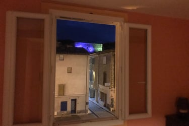 Double bedroom at night with illuminated Quillan castle view