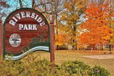 Rivermont's Riverside Park main entrance sign in autumn