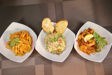 three plates of pasta Penne, Carbonara and Seafood Marinara