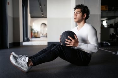 a young man holding a medicine ball