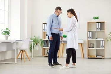 a doctor examining a patient's waist with a measuring tape measure tape