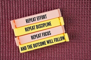 Motivational quote on colorful clips: Repeat effort, discipline, and focus for the best outcome.