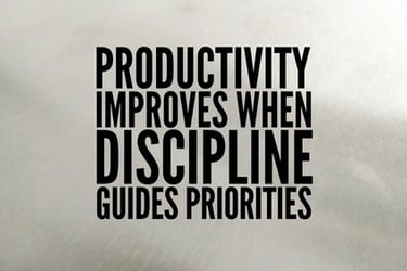 A motivational quote about productivity and discipline on a grey background.