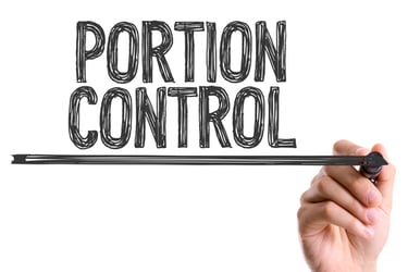 A hand writing the words Portion Control on a transparent glass board for diet and nutrition planning.