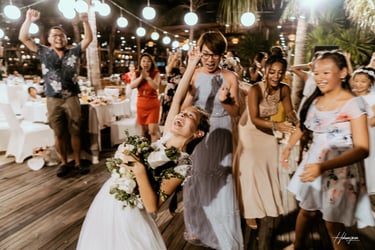 a bride and groomsmid are dancing in a wedding party