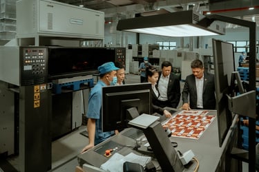 a group of people standing around a table with a chess board