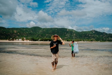 a man and a woman are walking on the beach