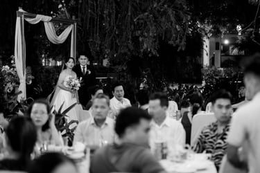 a bride and groom are standing in a garden