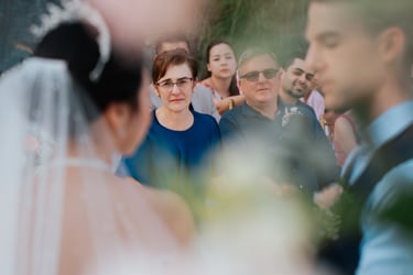 a bride and groomsmid are standing in front of a crowd