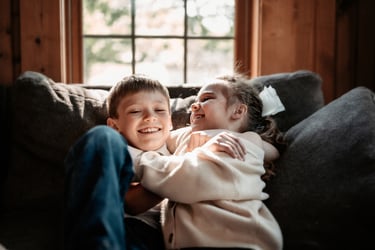 Joyful moment of siblings falling back and laughing, Duluth Minnesota