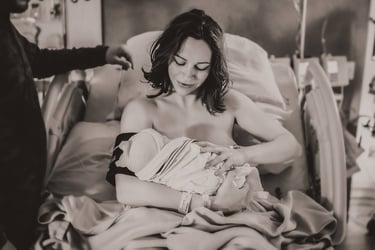 Mama cradling her newborn baby in a hospital bed in Grand Rapids, MN.