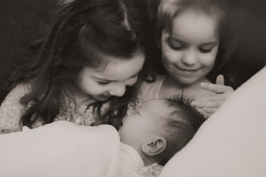 Sisters holding newborn baby brother, Grand Rapids MN