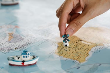 a person holding a small toy car on a map