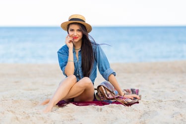 a woman sitting on a blanket on a blanket