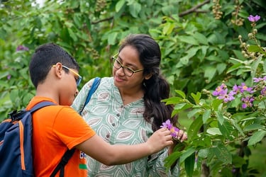 una mujer y un niño miran flores y hablan