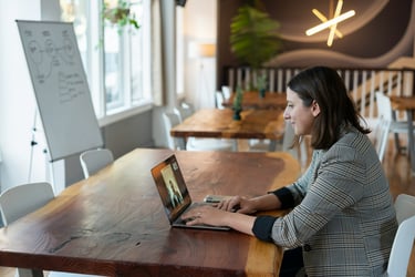 A woman attending a virtual call in an office setting.