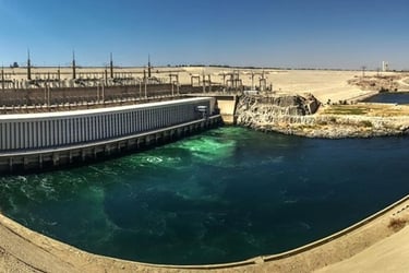 a dam of water flowing over a dam in the middle of a desert
