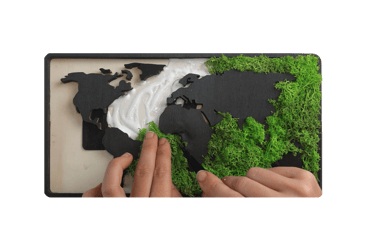 a person holding a piece of paper with a map of the world