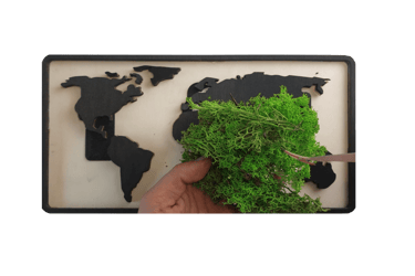 a person cutting a piece of wood with a map of the world