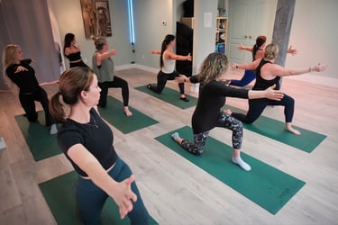 Females doing yoga at a Class at The Iron Cactus Yoga Studio, 2026