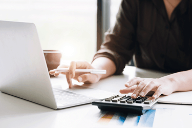a woman sitting at a desk with a calculator