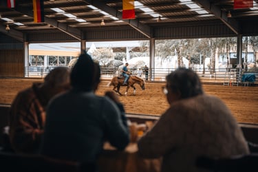 a man riding a horse in a barn