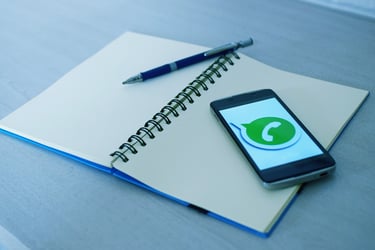 a cell phone and a pen on a notebook