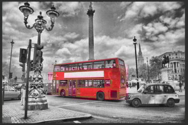 a red double decker bus parked in front of a statue of a man