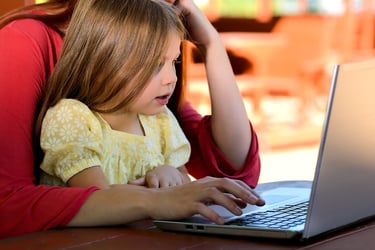 Mother and girl using a laptop
