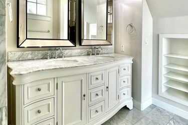 Bathroom with traditional architectural style, beautiful radius wood vanity, and marble countertops.