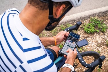 a cyclist reviewing a planned training session on their phone