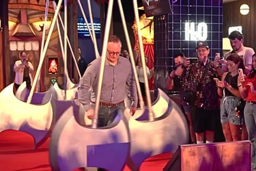 Level 99 Disney Springs CEO Matt DuPlessie playing the Axe Run challenge game among large swinging axes.