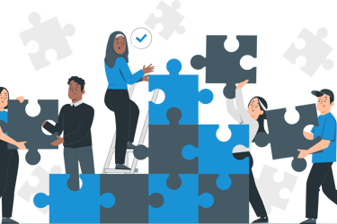 a group of people standing around a puzzle piece of puzzle pieces
